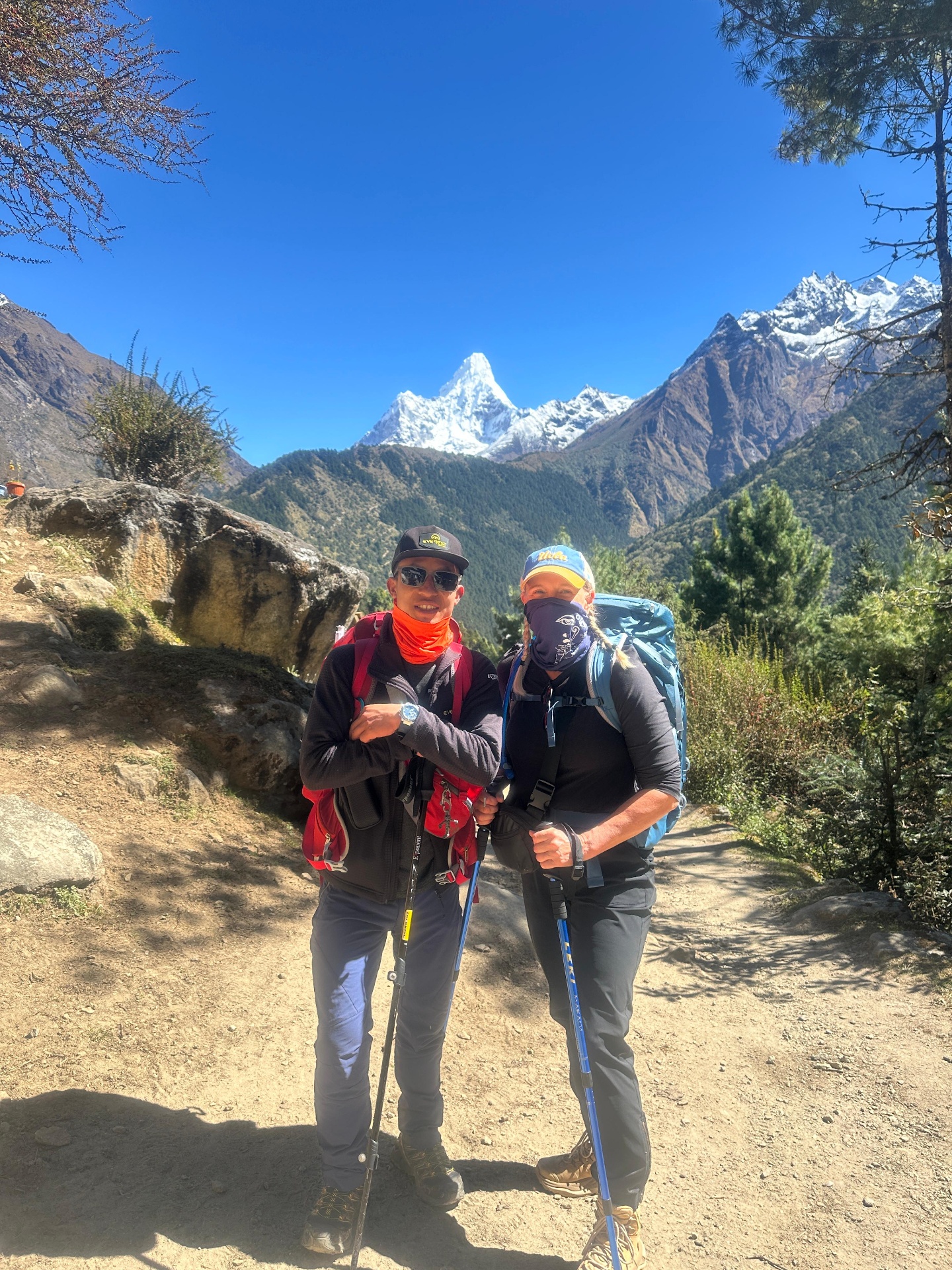 Bhupal and a trekker resting with Ama Dablam in the distance