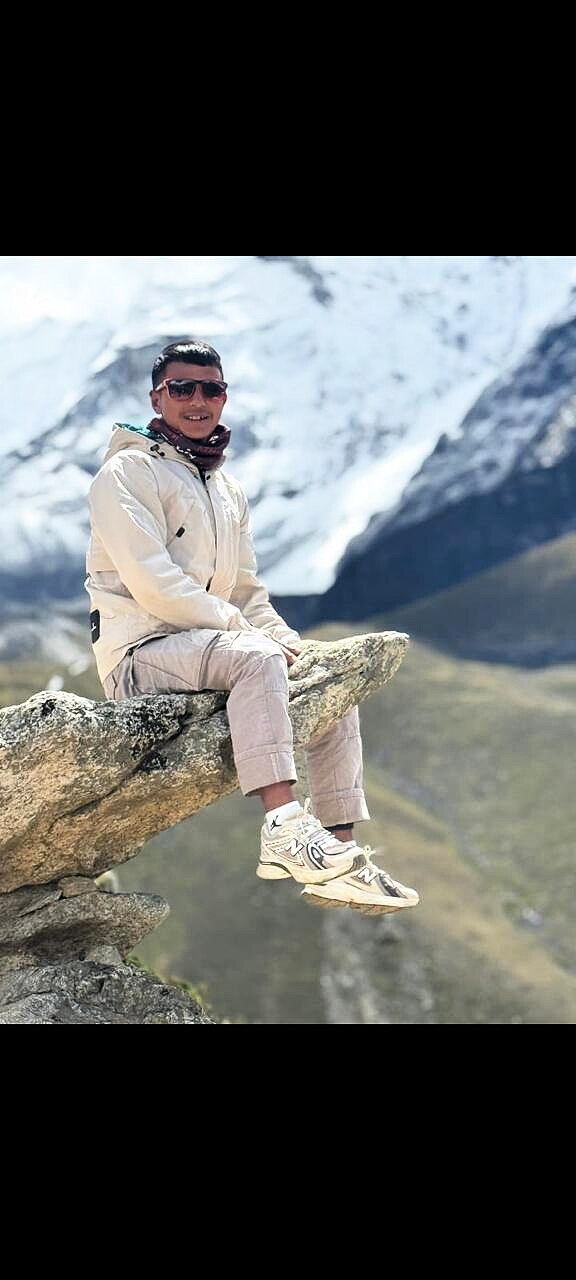 Kumar Magar standing in front of Ama Dablam in the Khumbu
